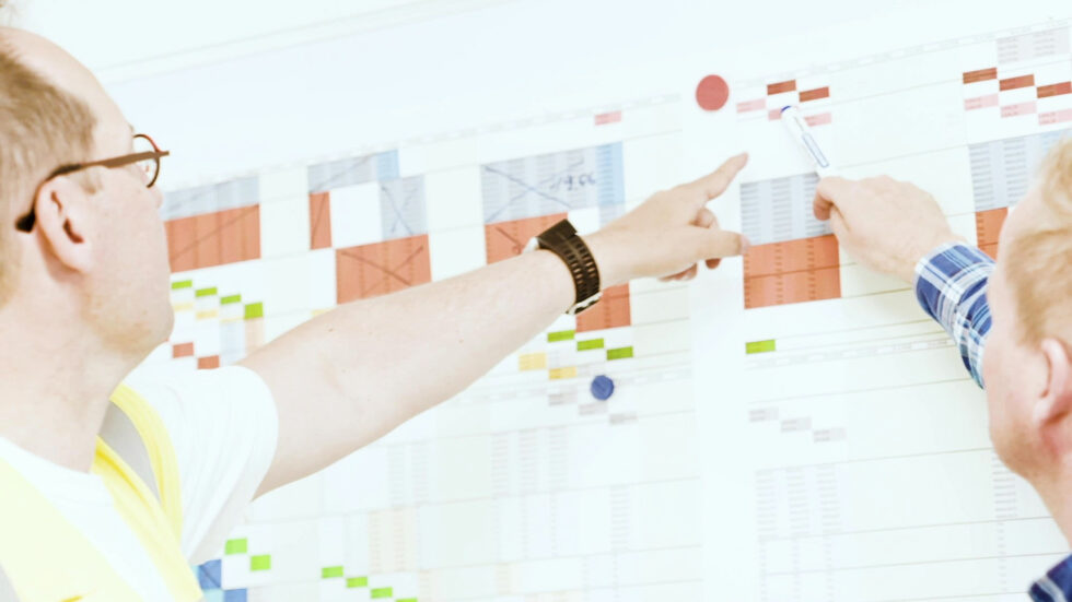 People review the project schedule for a construction site
